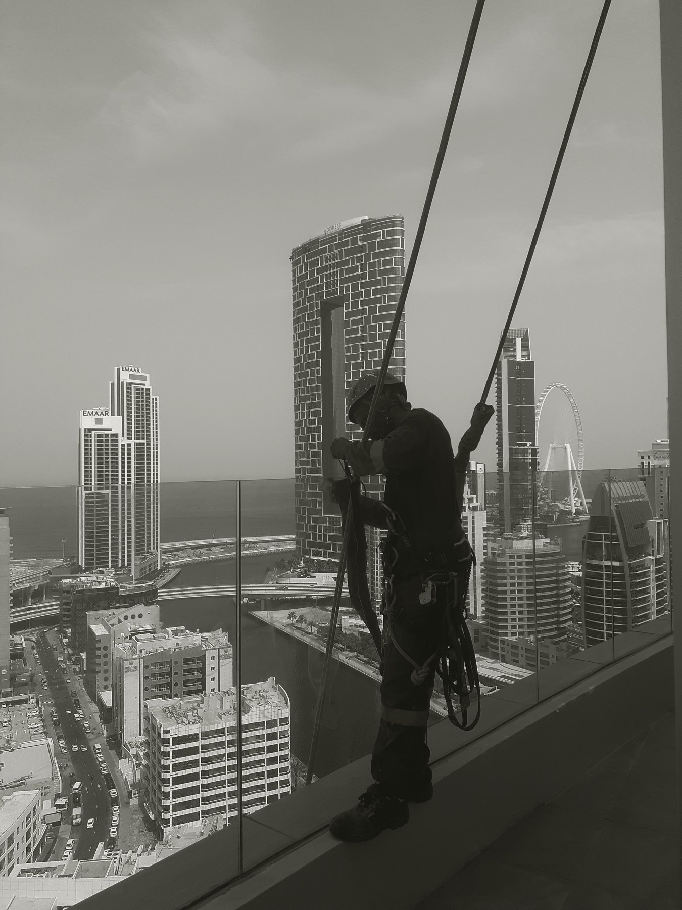 Arabian Height technician on rope access at height above Dubai Marina